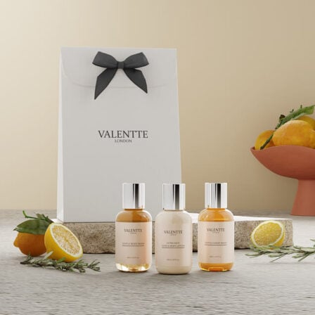 Our Uplifting Body care colleciton, Showcasing 3 travel size products, surrounded by lemons, rosemary and Neroli