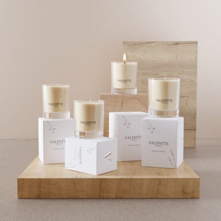 Our buy 2 Get 2 free candles - on a wooden board with their boxes