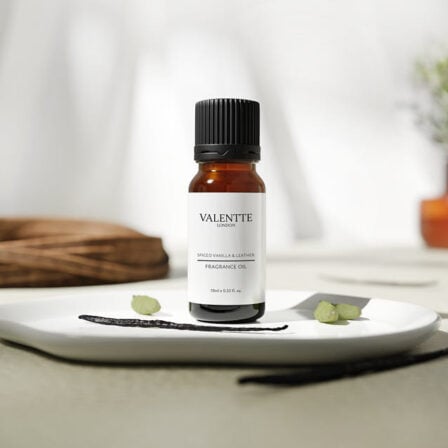 Our spiced vanilla and leather fragrance oil on a plate, with vanilla bean